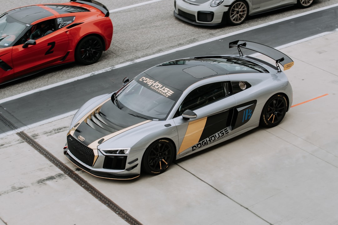 Gray and black Audi R8 coupe on open asphalt road during daytime